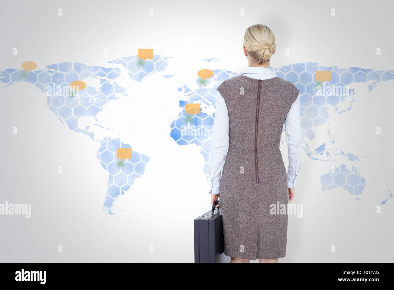 Composite image of back turned businesswoman holding a briefcase Stock Photo