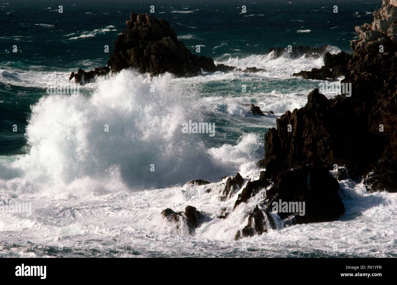 Rough sea, waves breaking on the rocky coast of the Island of Ouessant ...