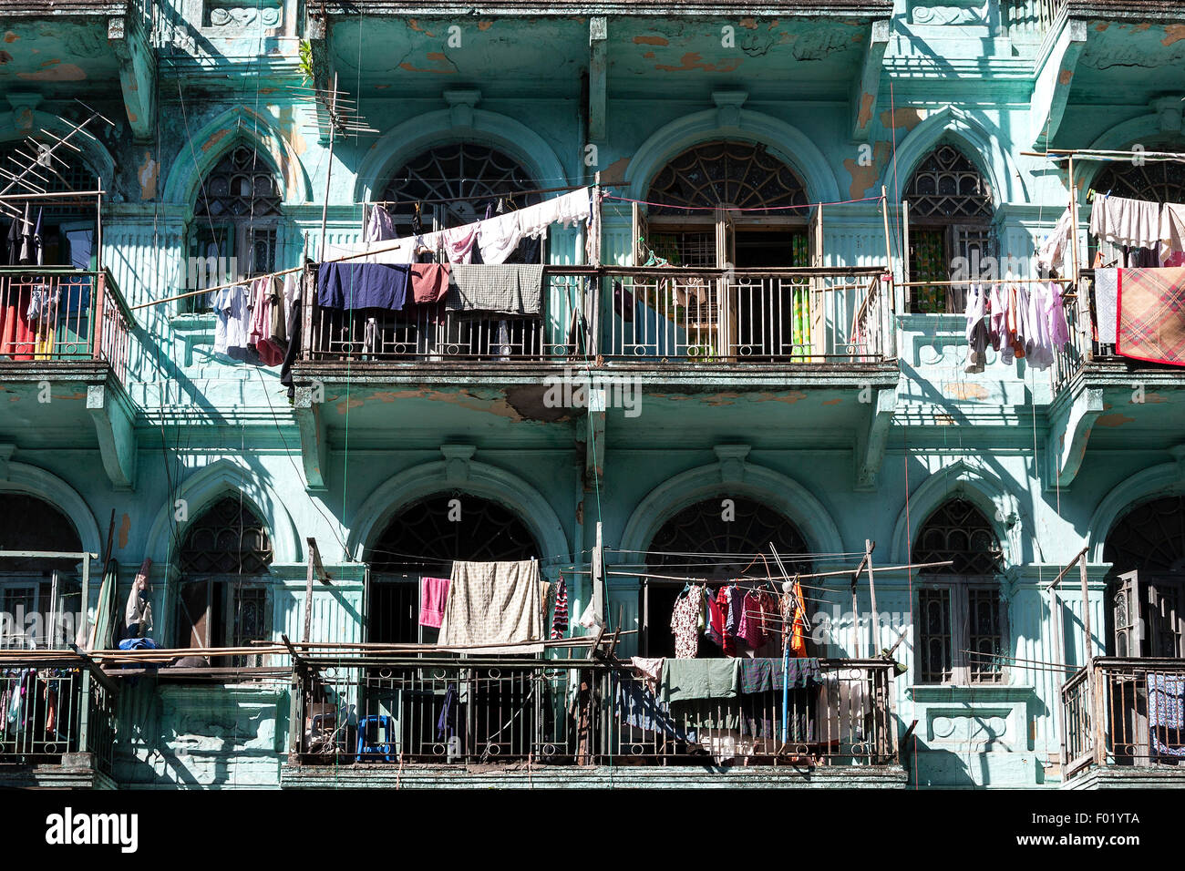 Facade of an old house, laundry hanging on balconies, Yangon, Myanmar