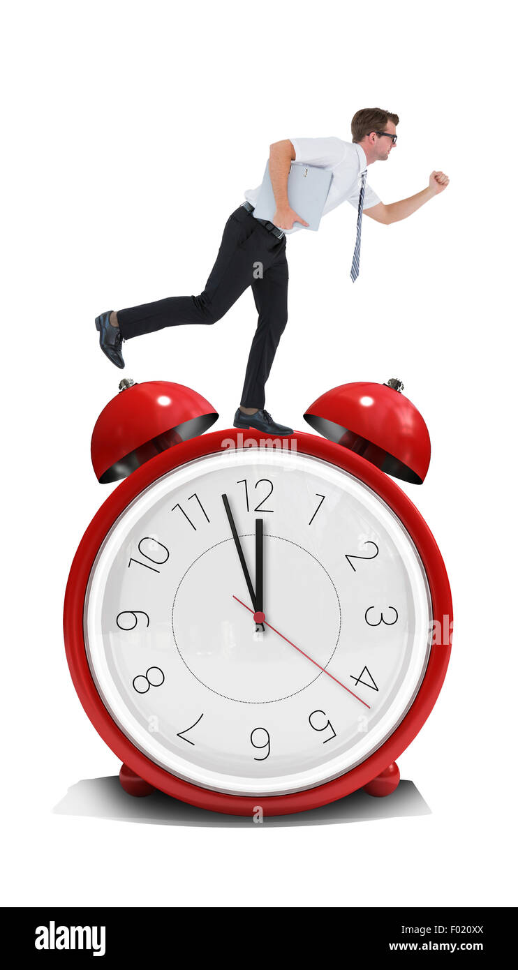 Composite image of geeky businessman running late Stock Photo