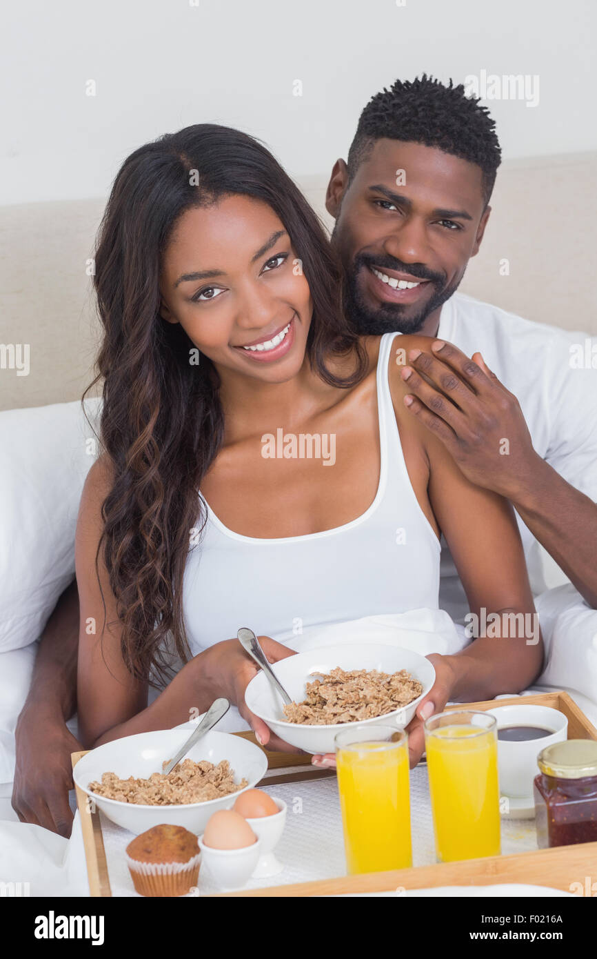 Relaxed couple having breakfast in bed together Stock Photo Alamy