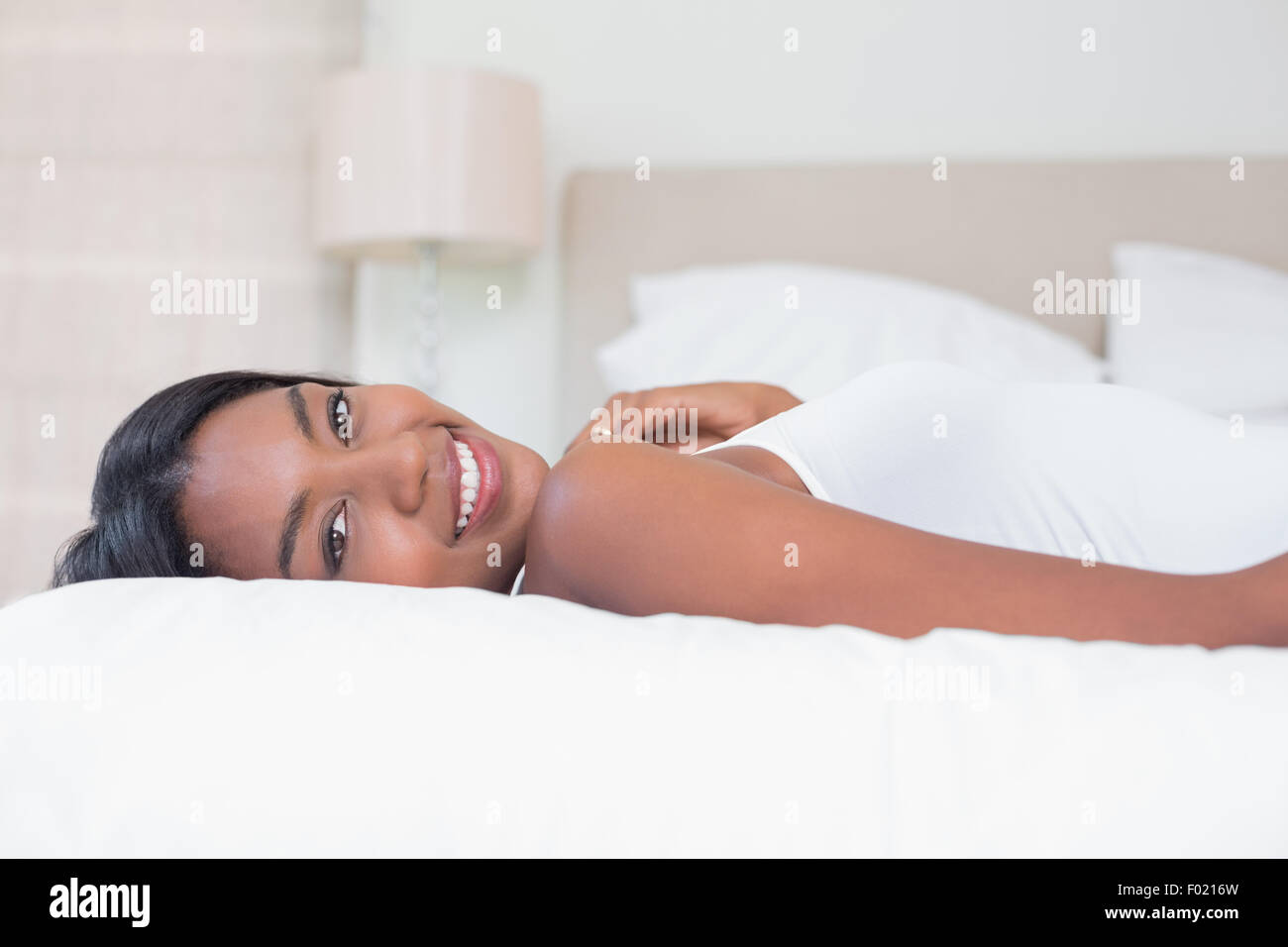 Relaxed woman lying on bed Stock Photo Alamy