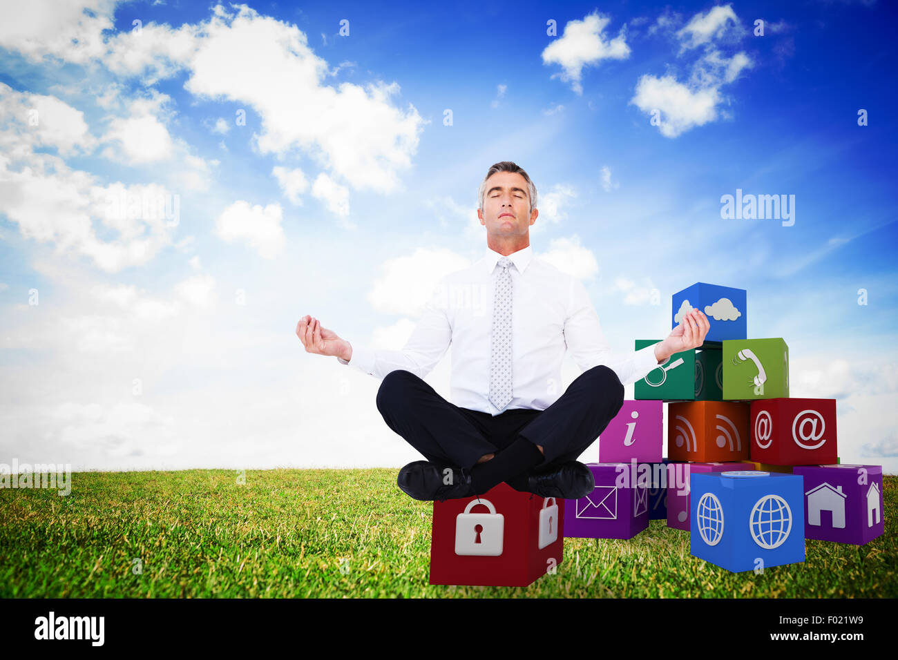 Composite image of zen businessman meditating in lotus pose Stock Photo