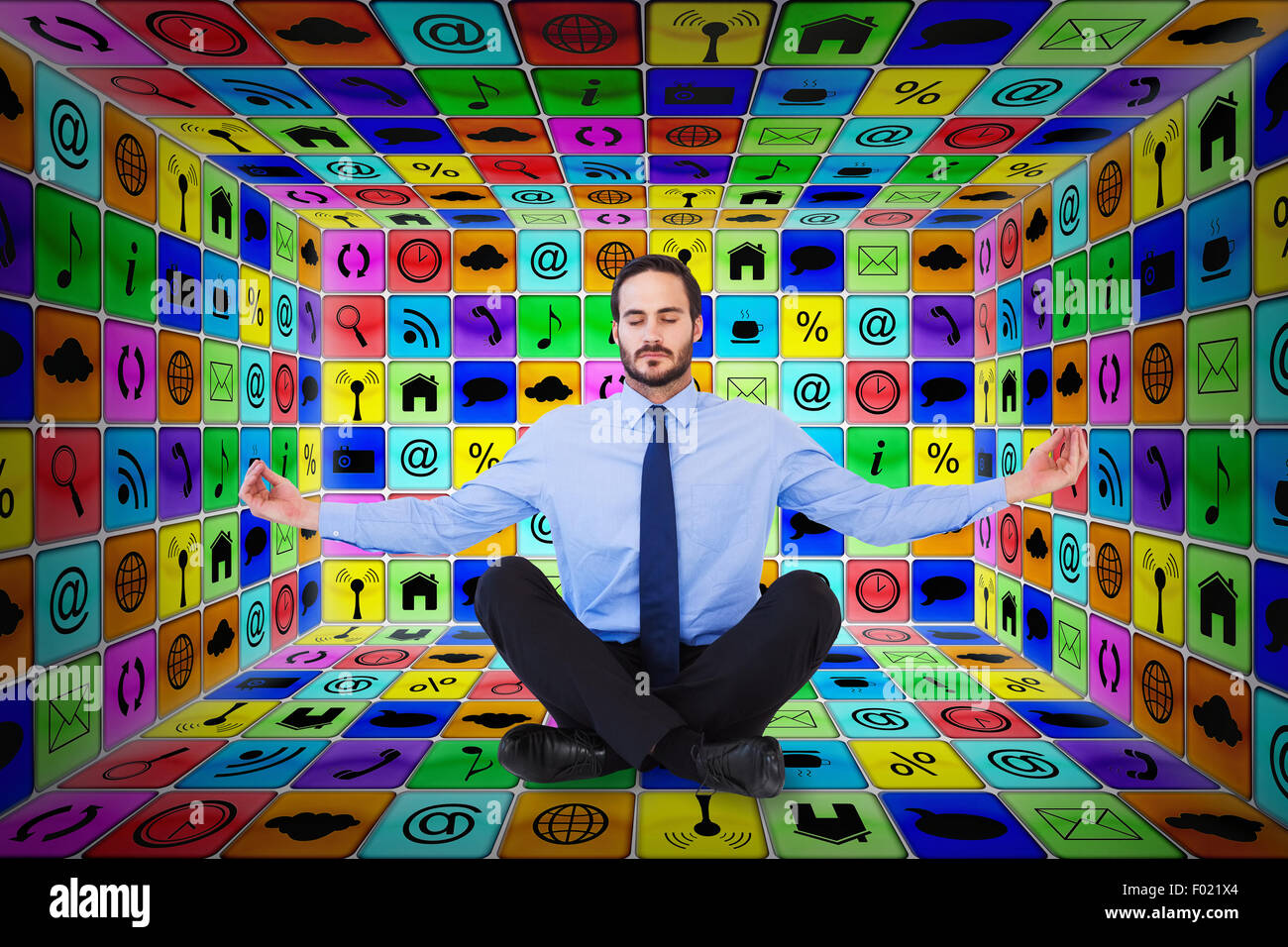 Composite image of businessman in suit sitting in lotus pose Stock Photo