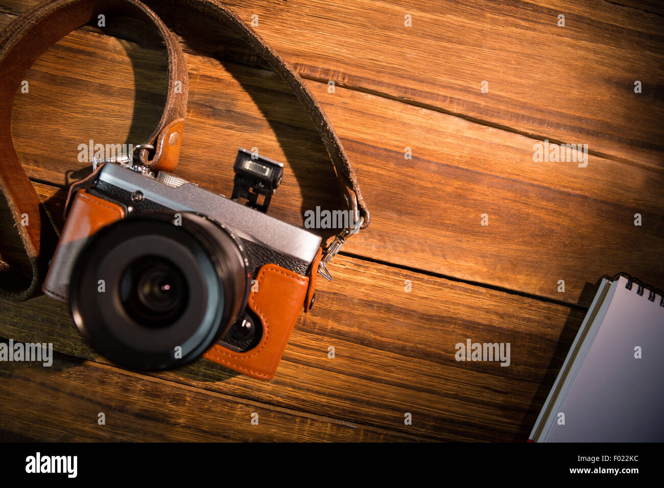 Camera Notepad A beautiful fashioned camera next to the notepad Stock Photo - Alamy