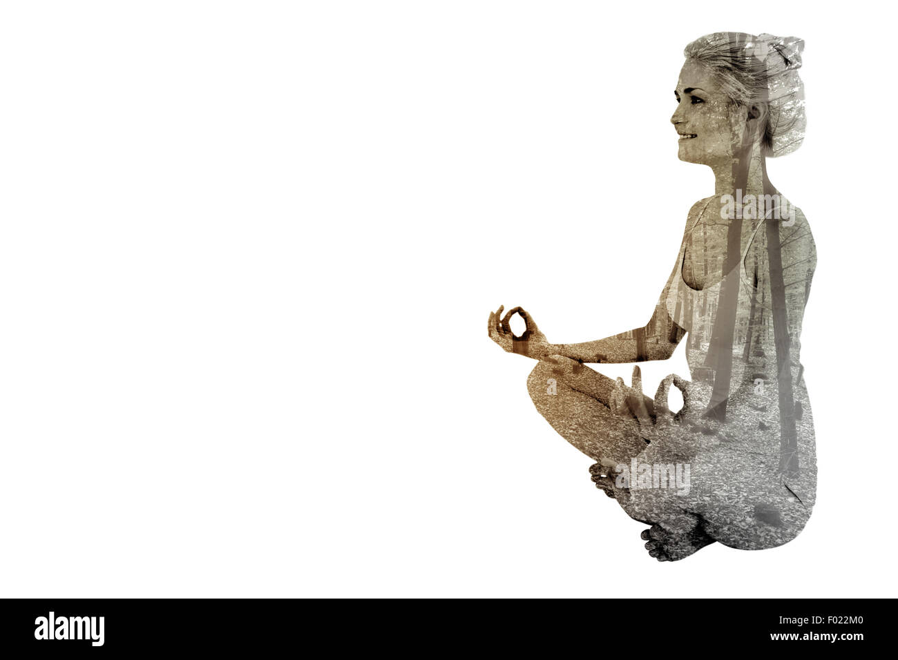 Composite image of full length of toned woman sitting in lotus position Stock Photo