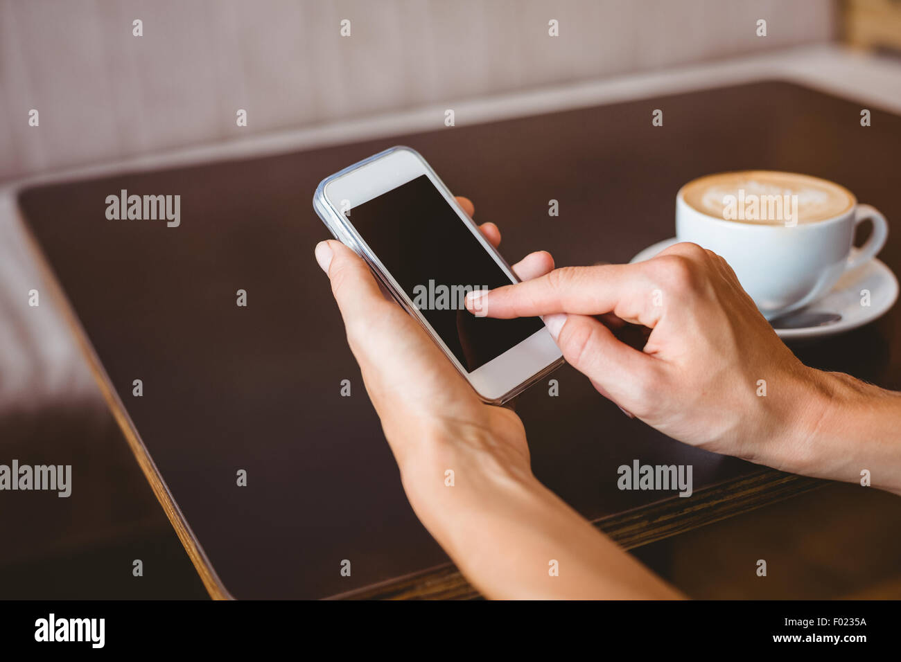 Hand of woman holding smartphone Stock Photo