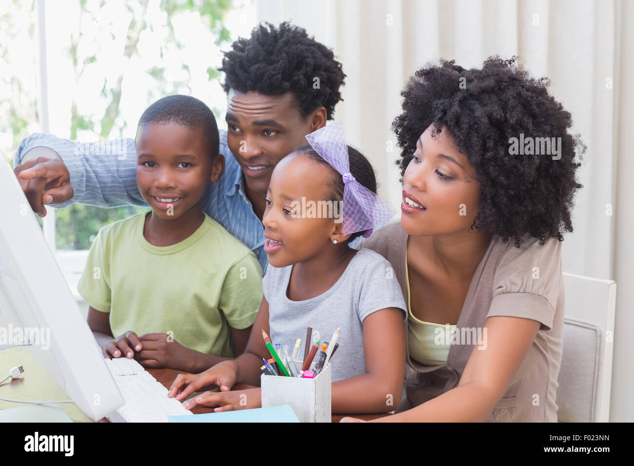 Happy family using the computer Stock Photo - Alamy