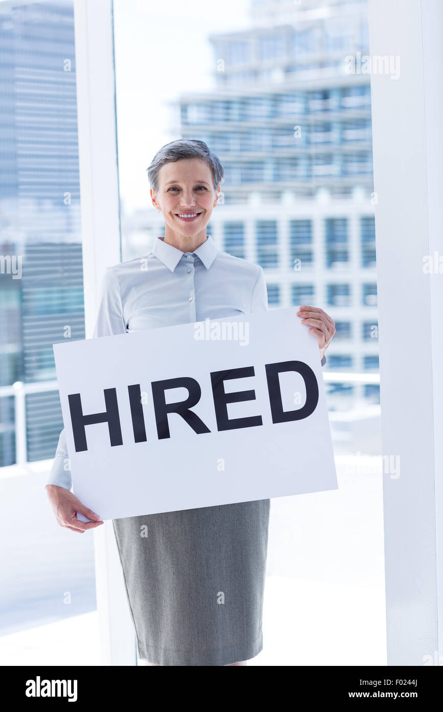Businesswoman holding a signboard hired Stock Photo