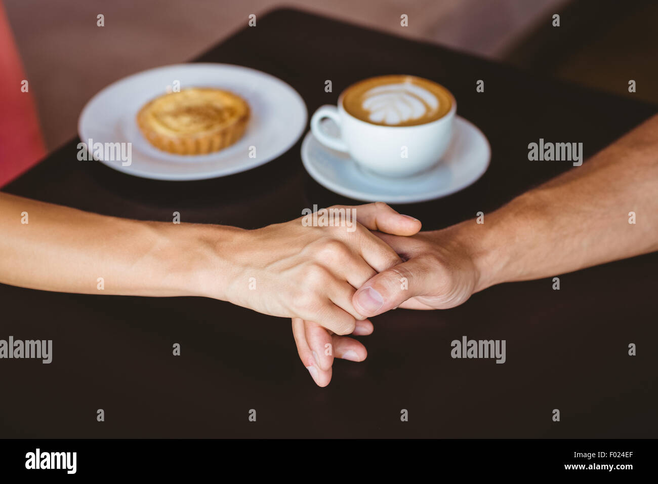 Cute couple on a date holding hands Stock Photo