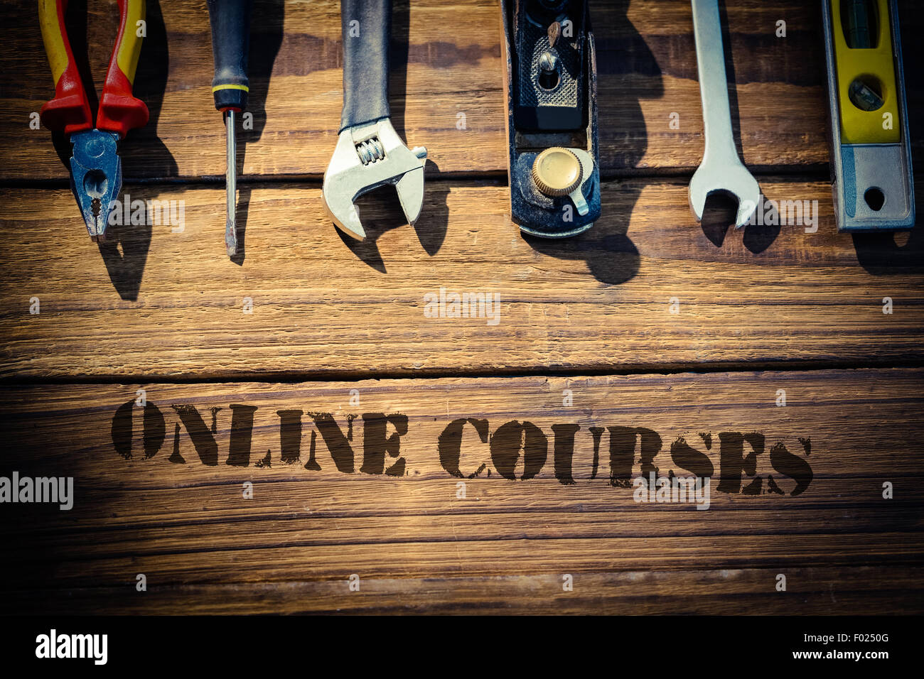Online courses against desk with tools Stock Photo
