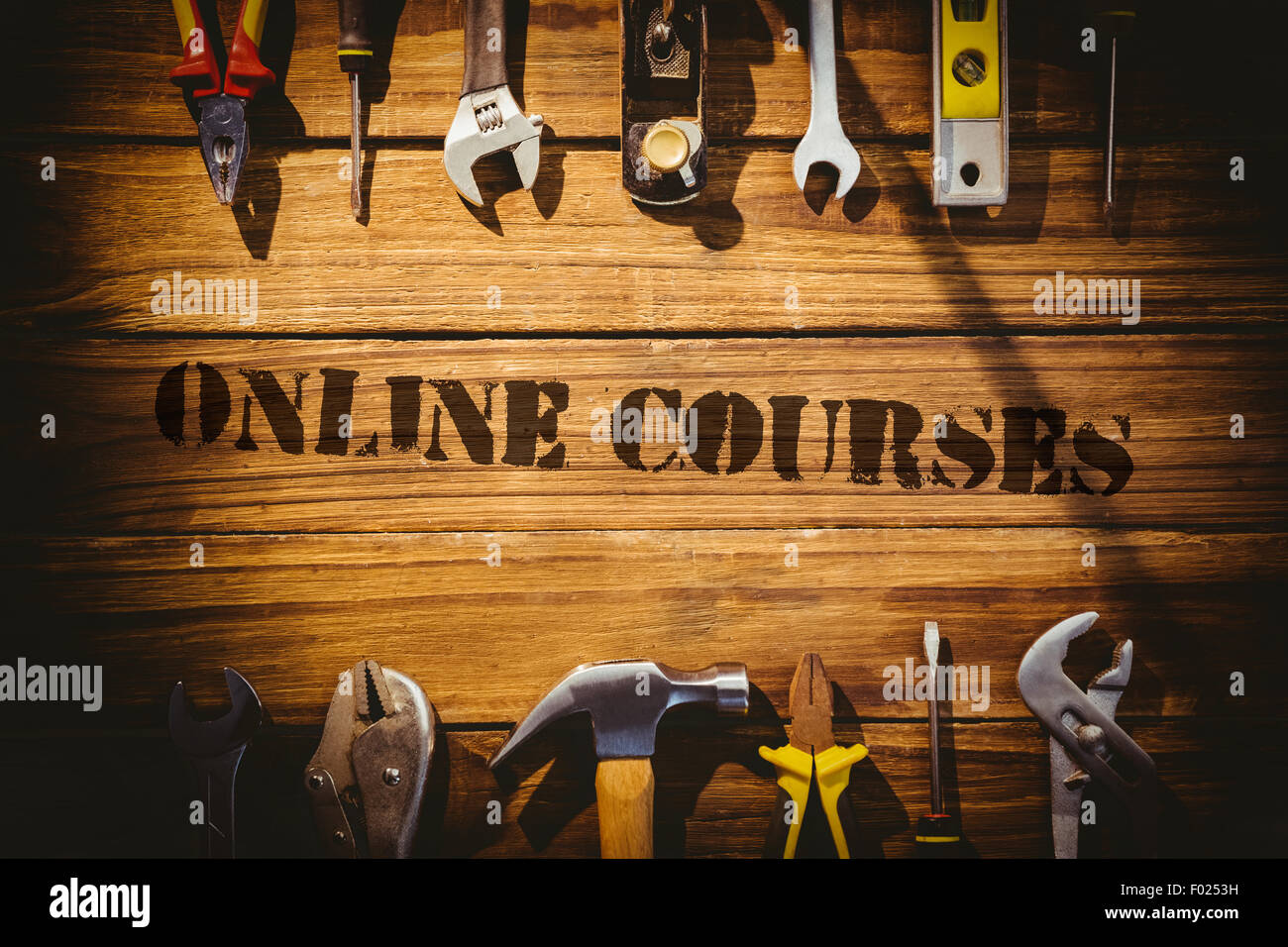 Online courses against desk with tools Stock Photo