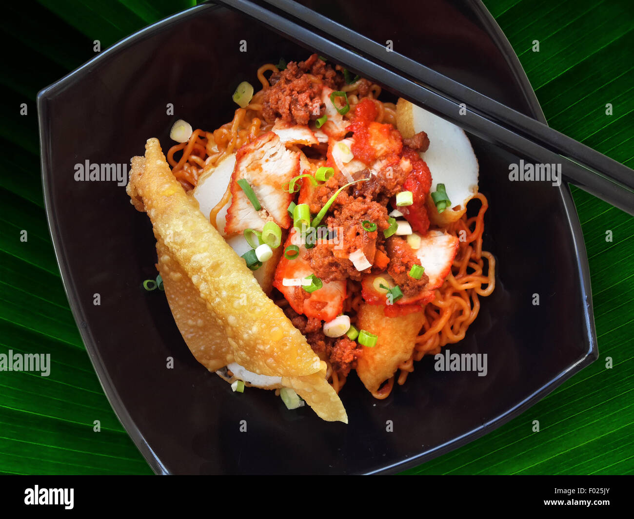 Bowl of Spicy chicken with noodles Stock Photo