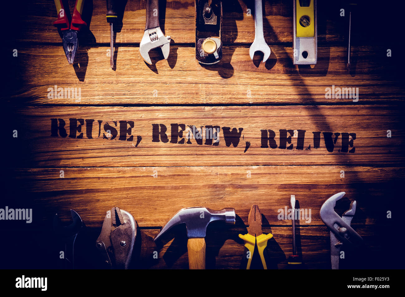 Reuse, renew, relive against desk with tools Stock Photo