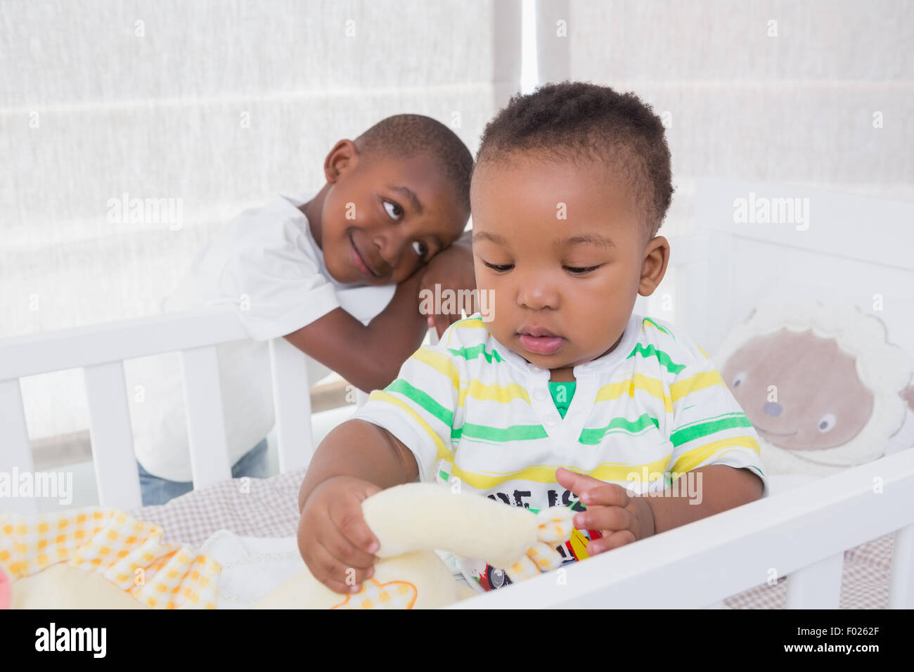 Babyboy and his brother in babyroom Stock Photo