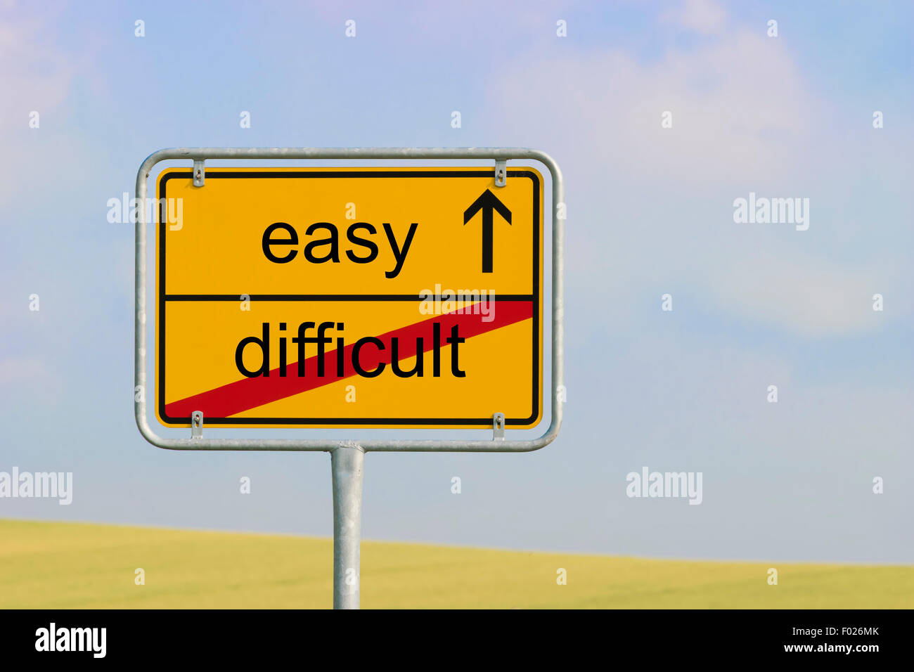 Yellow town sign with text 'difficult easy' Stock Photo