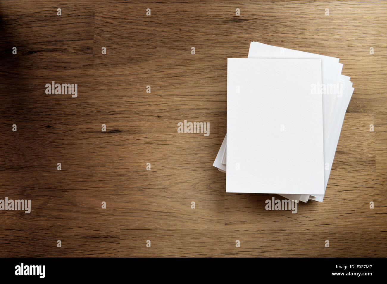 Paper blank card and free space on a wooden table Stock Photo