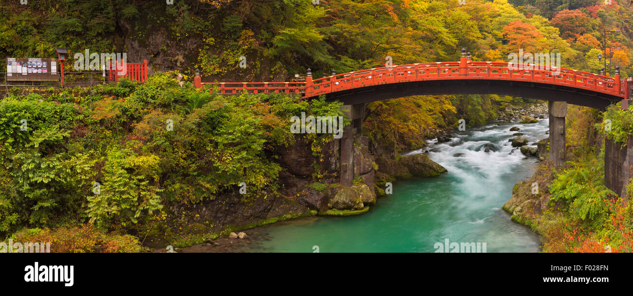 The Shinkyo Sacred Bridge (神橋) in Nikko, Japan over the Daiya River surrounded by bright autumn colors. Stock Photo