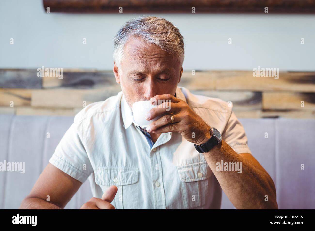 Casual man enjoying a cup of coffee Stock Photo