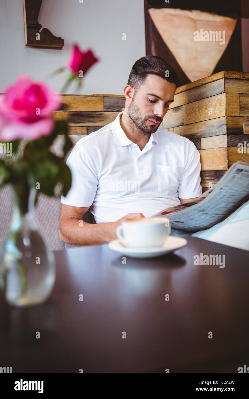Young man reading a newspaper Stock Photo - Alamy