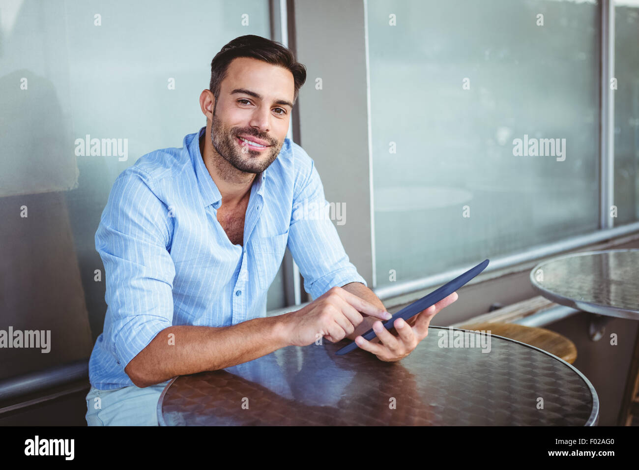 Smiling businessman using a tablet Stock Photo - Alamy