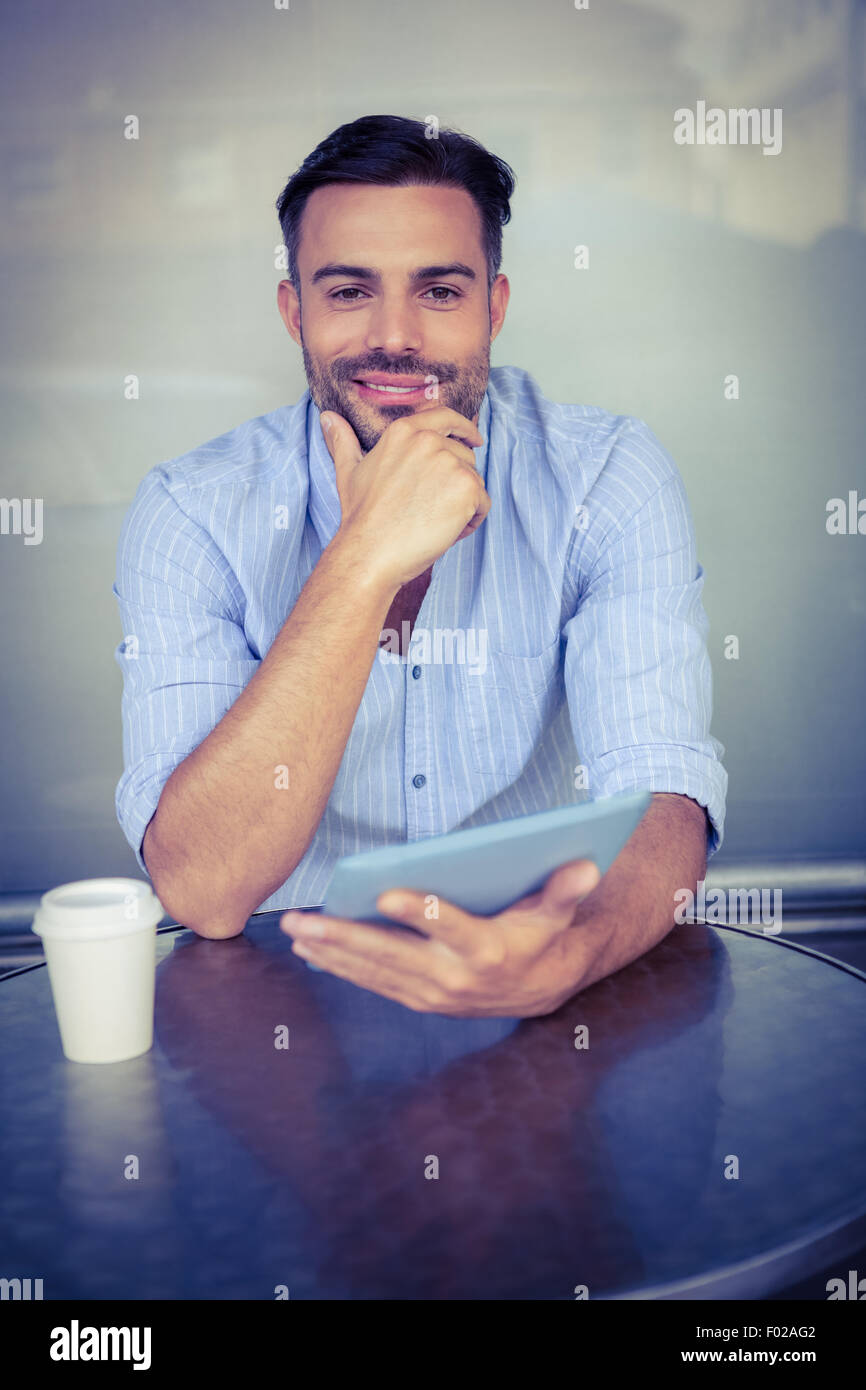 Smiling businessman using a tablet Stock Photo - Alamy
