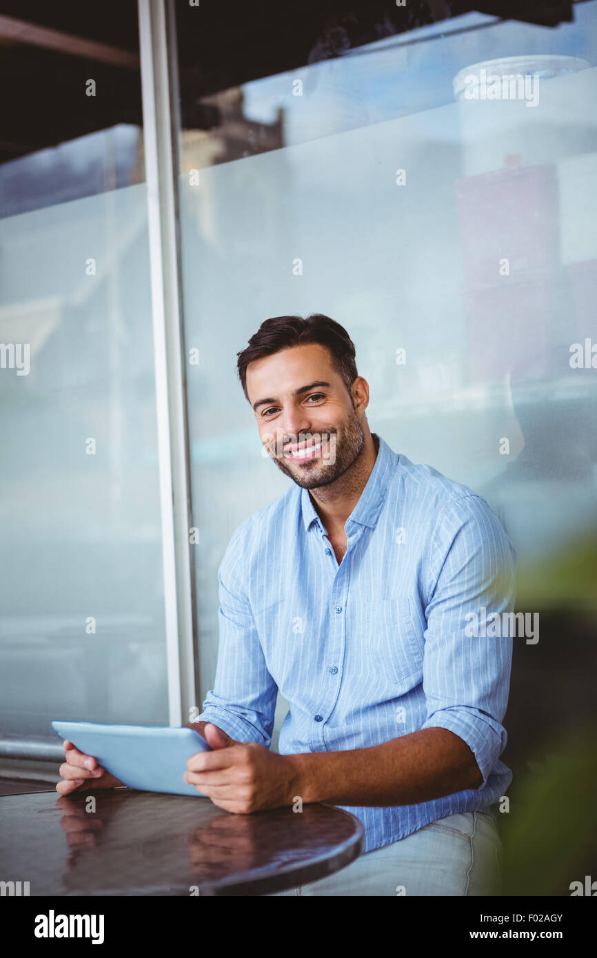 Smiling businessman using a tablet Stock Photo - Alamy