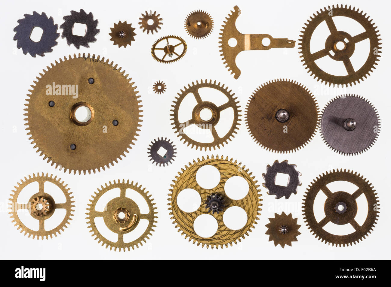 Selection of old brass clockwork clock parts - Isolated Stock Photo