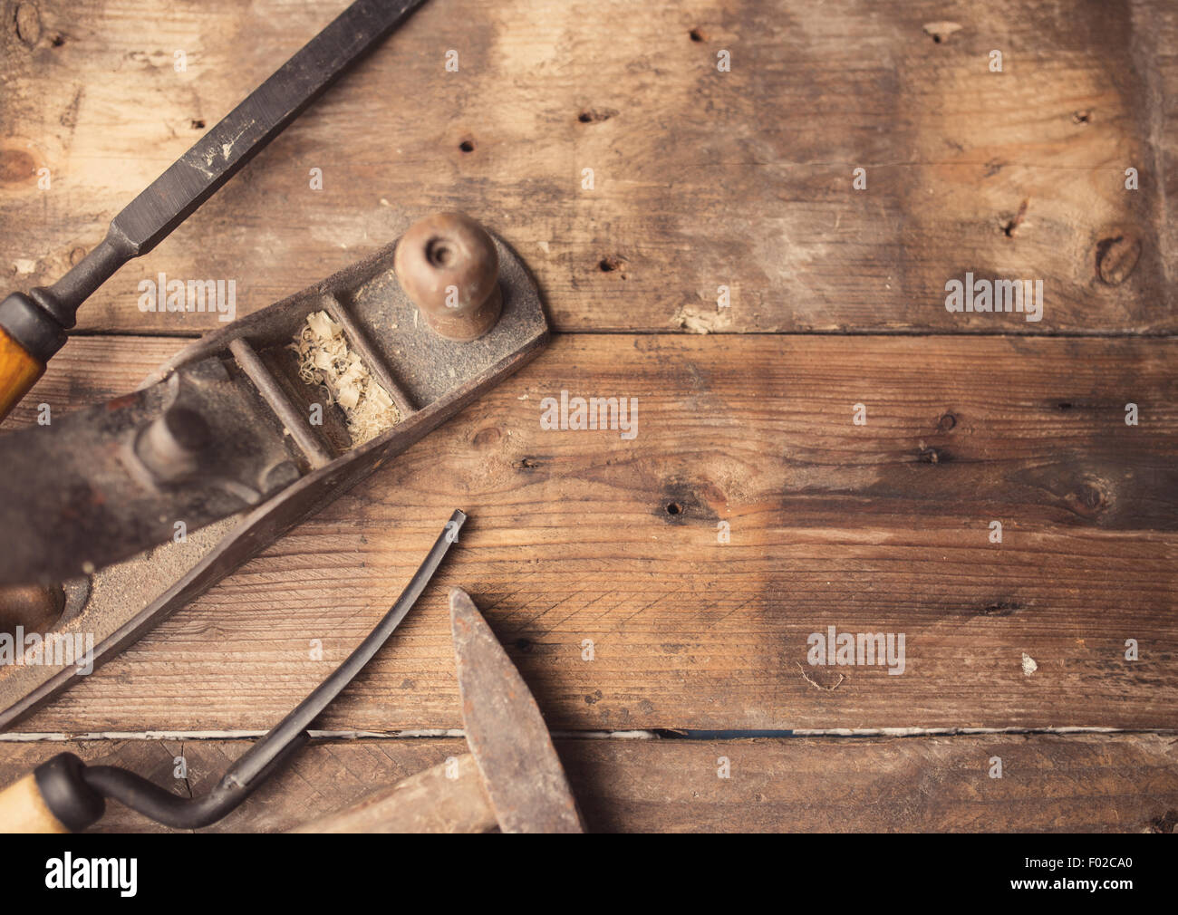 Od vintage hand tools on wooden background. Carpenter workplace Stock Photo
