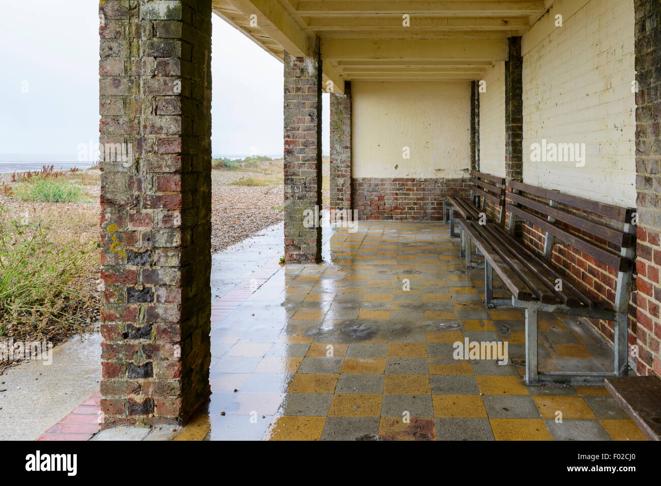 Underneath a brick shelter at the seaside on a wet day in Littlehampton, West Sussex, England, UK. Stock Photo