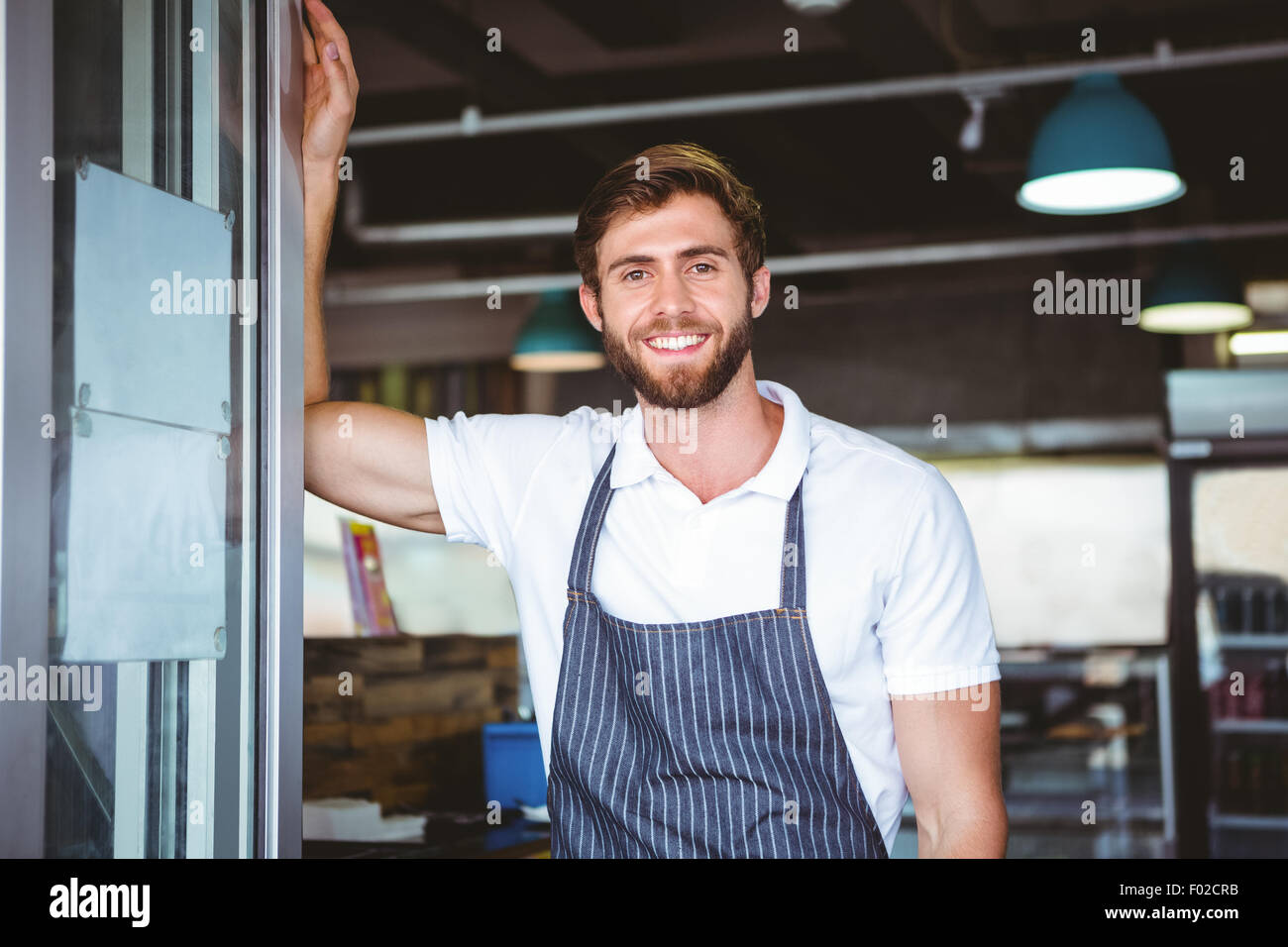 Smiling cafe owner in apron hi-res stock photography and images - Alamy