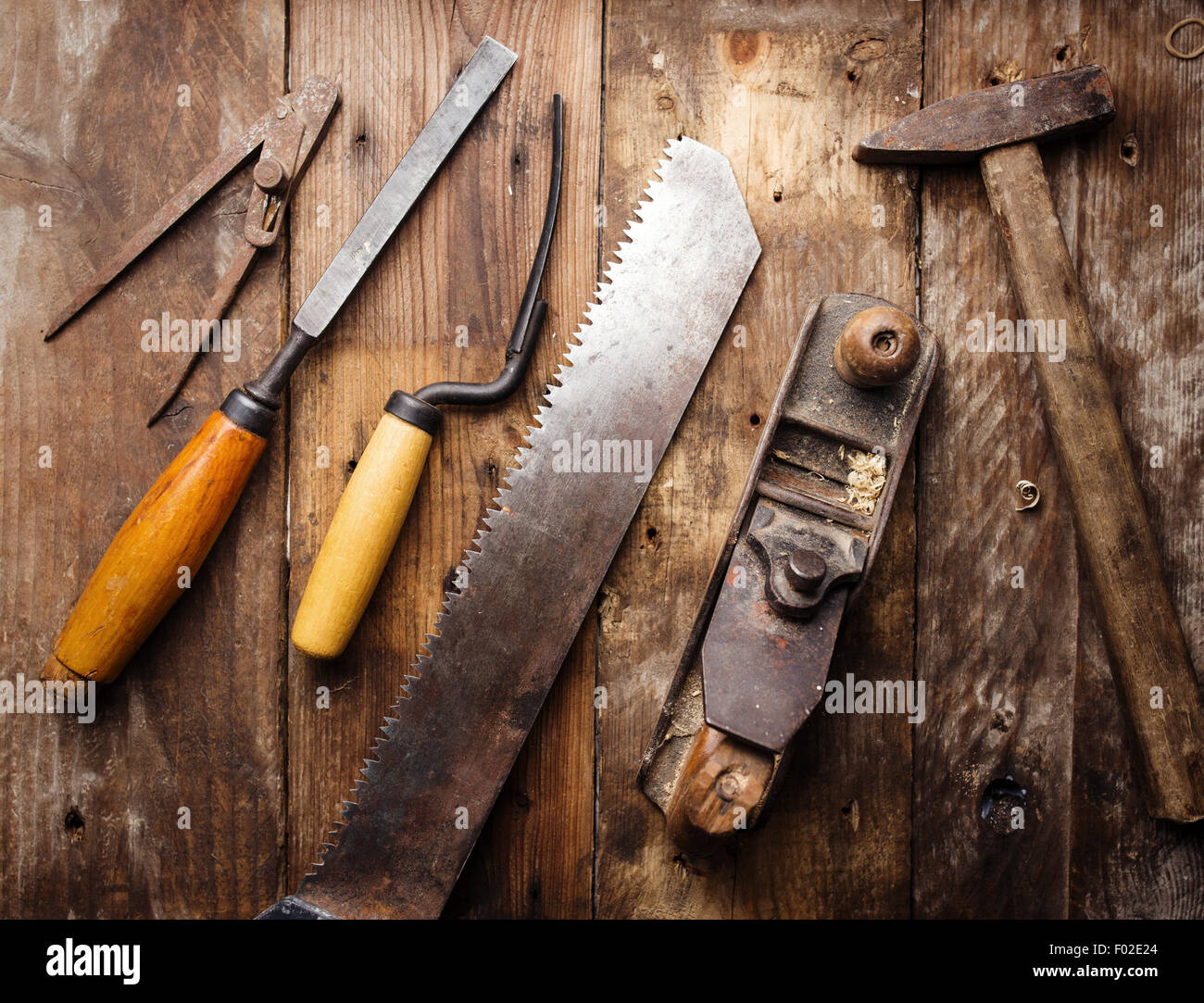 Od vintage hand tools on wooden background. Carpenter workplace Stock Photo