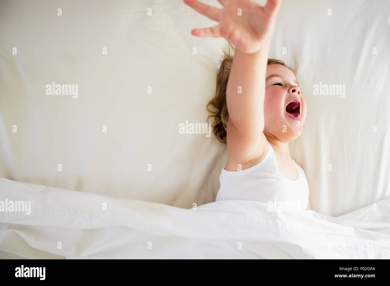 Girl in bed screaming Stock Photo
