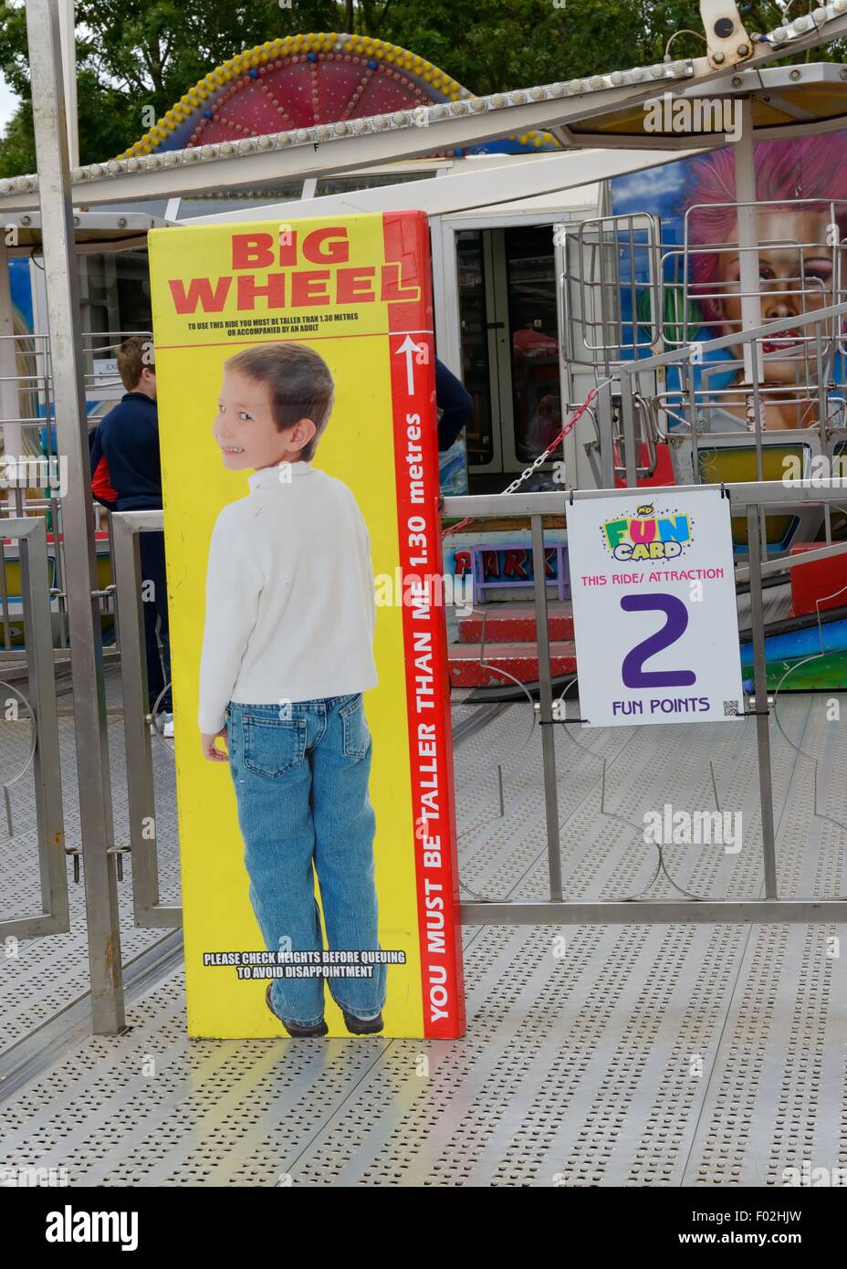 Height restriction chart for fun ride at fairground in Scotland, UK Stock Photo