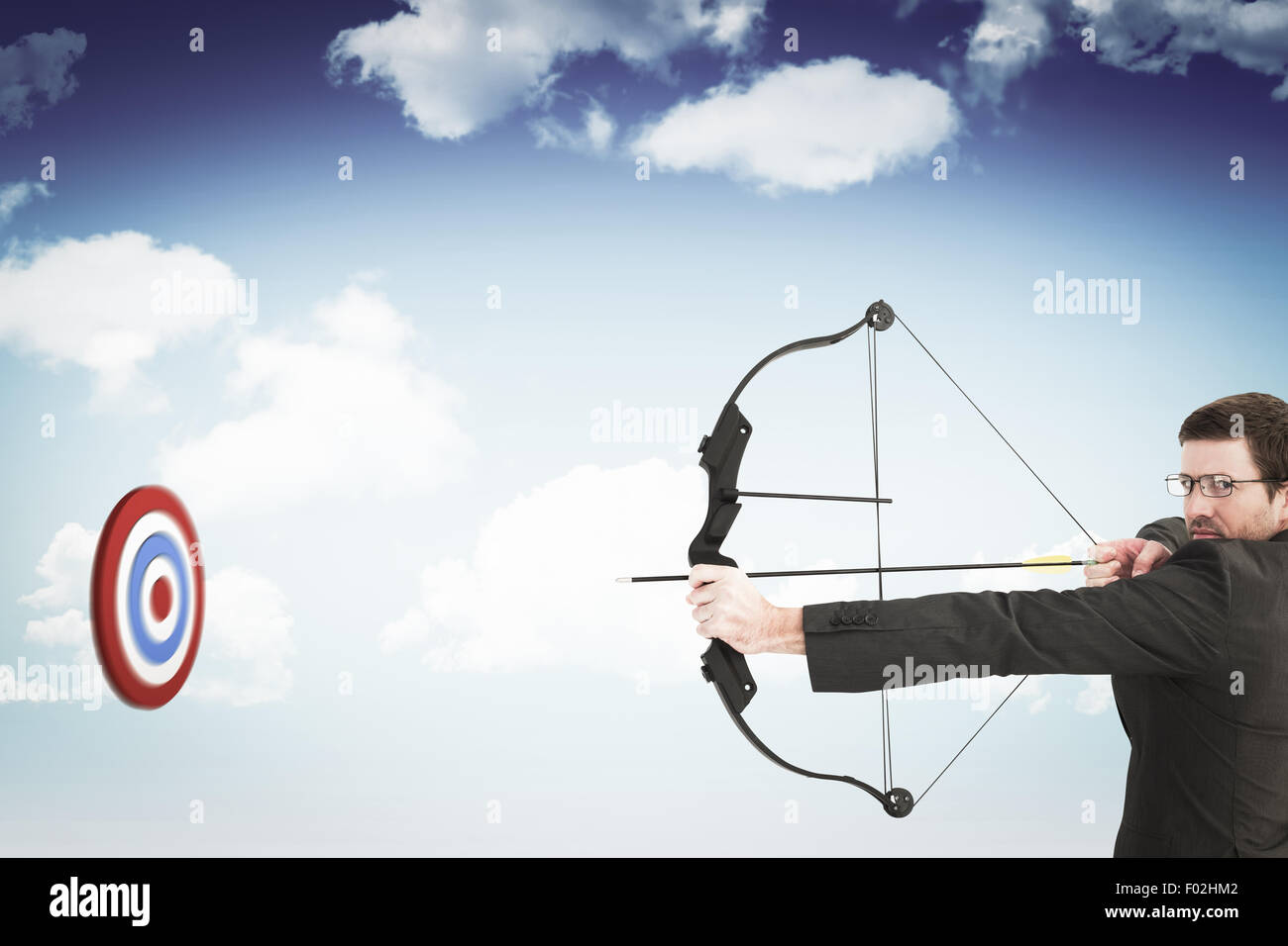Composite image of businessman shooting a bow and arrow Stock Photo