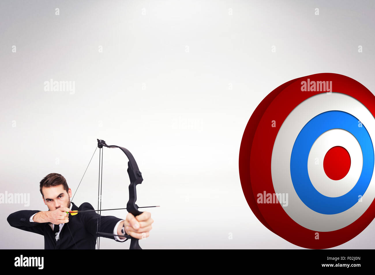 Composite image of smart businessman practicing archery looking at camera Stock Photo