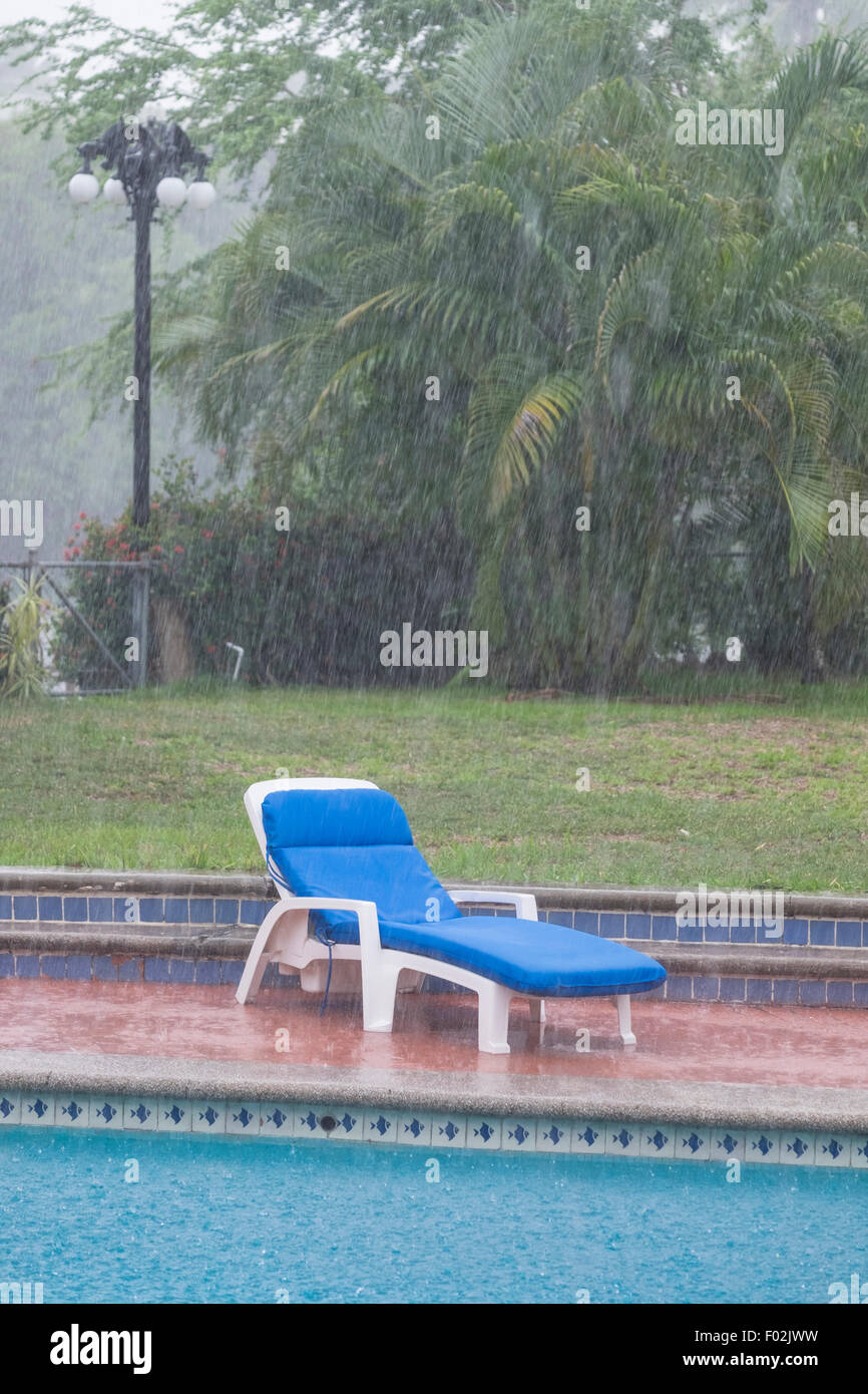 Heavy summer rain in residential backyard with swimming pool, Nayarit, Mexico Stock Photo