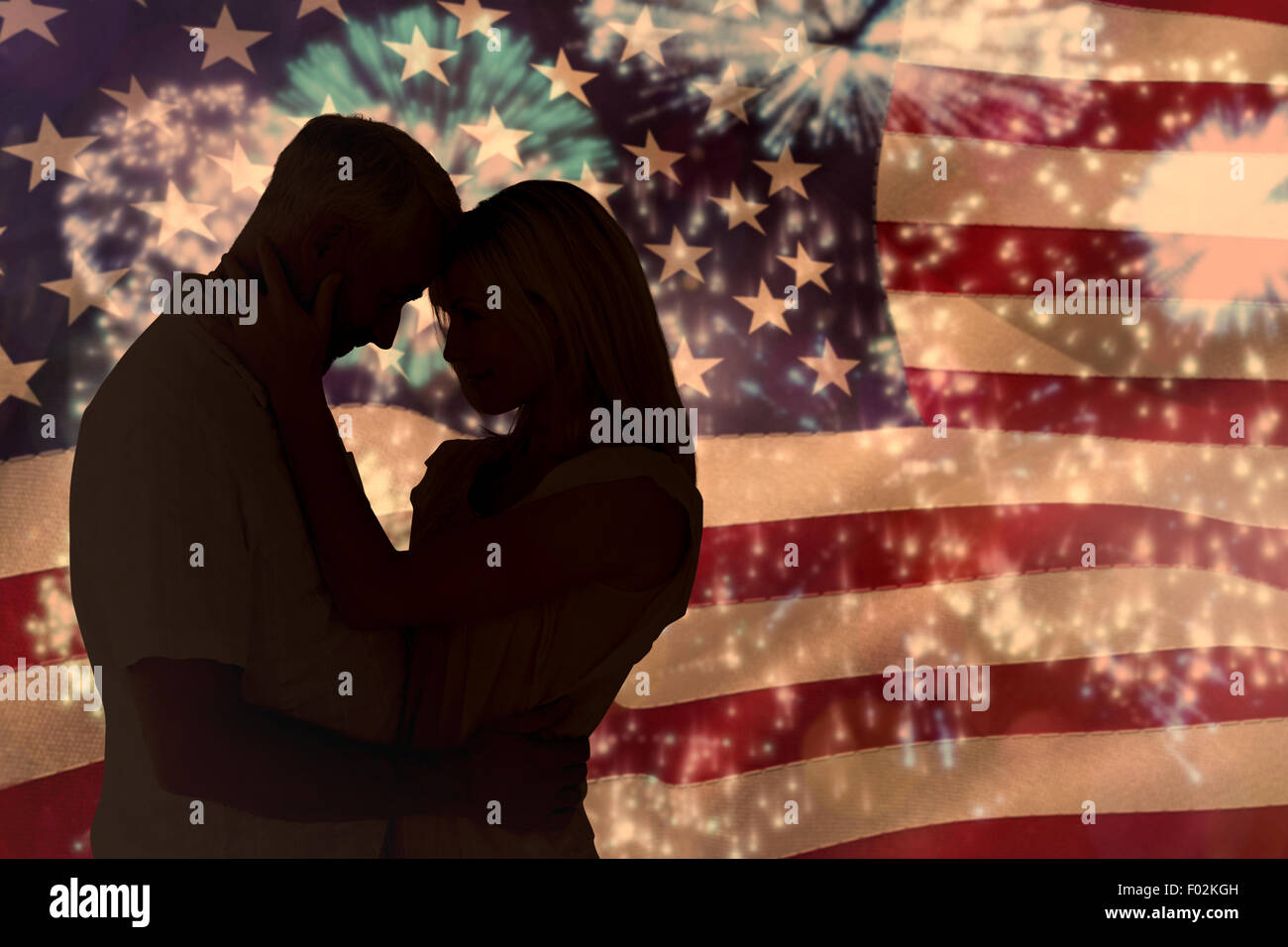 Composite image of affectionate couple standing and hugging Stock Photo