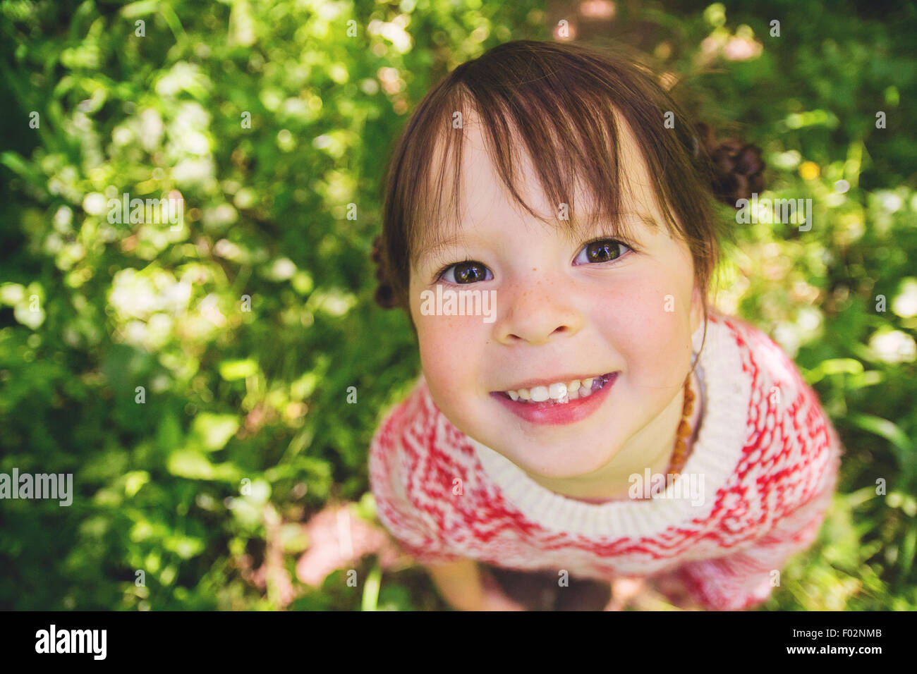 Smiling girl looking up Stock Photo