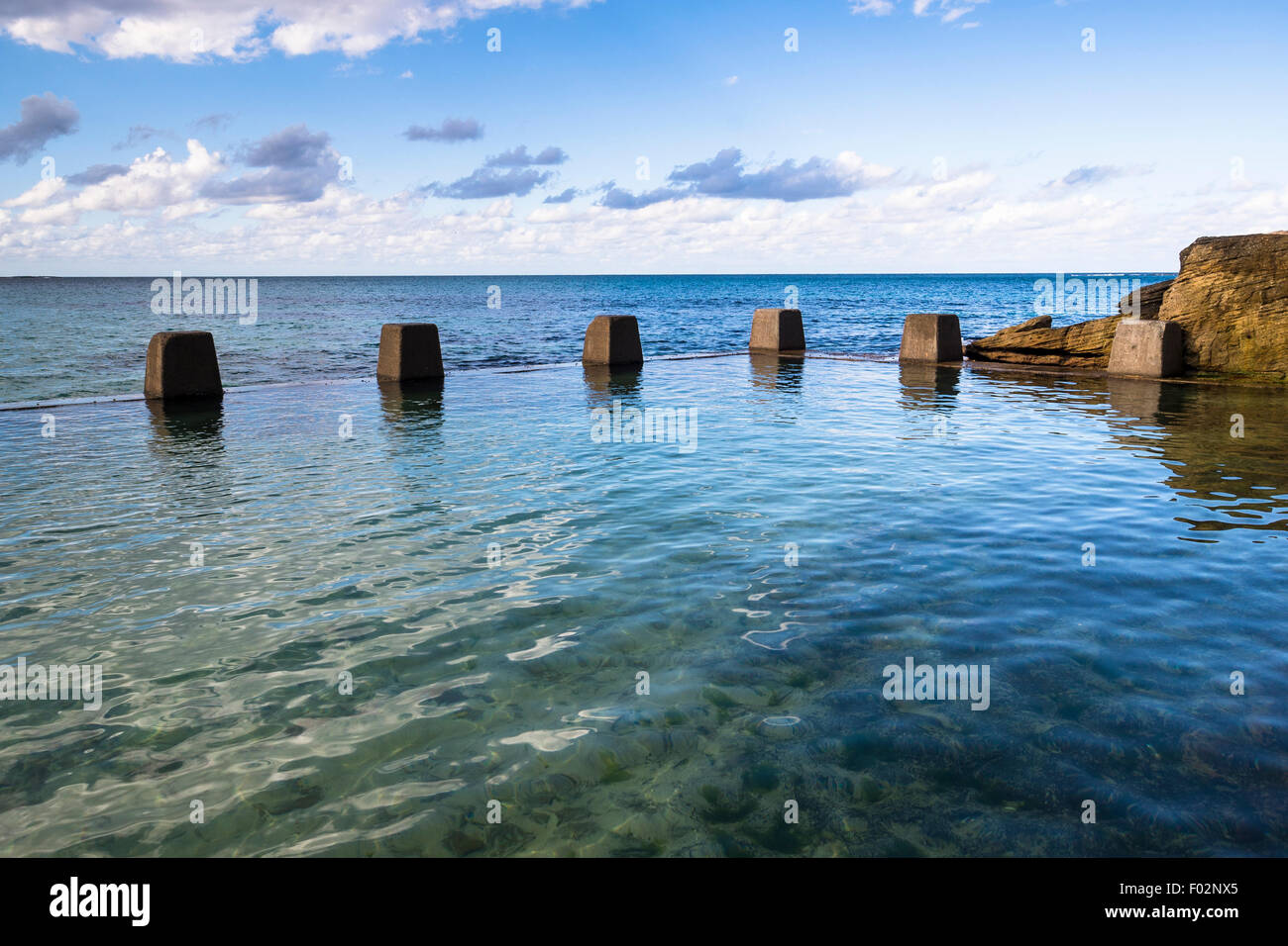 Swimming pool next to ocean, Ross Jones Memorial Pool, Coogee beach, Sydney, Australia Stock Photo