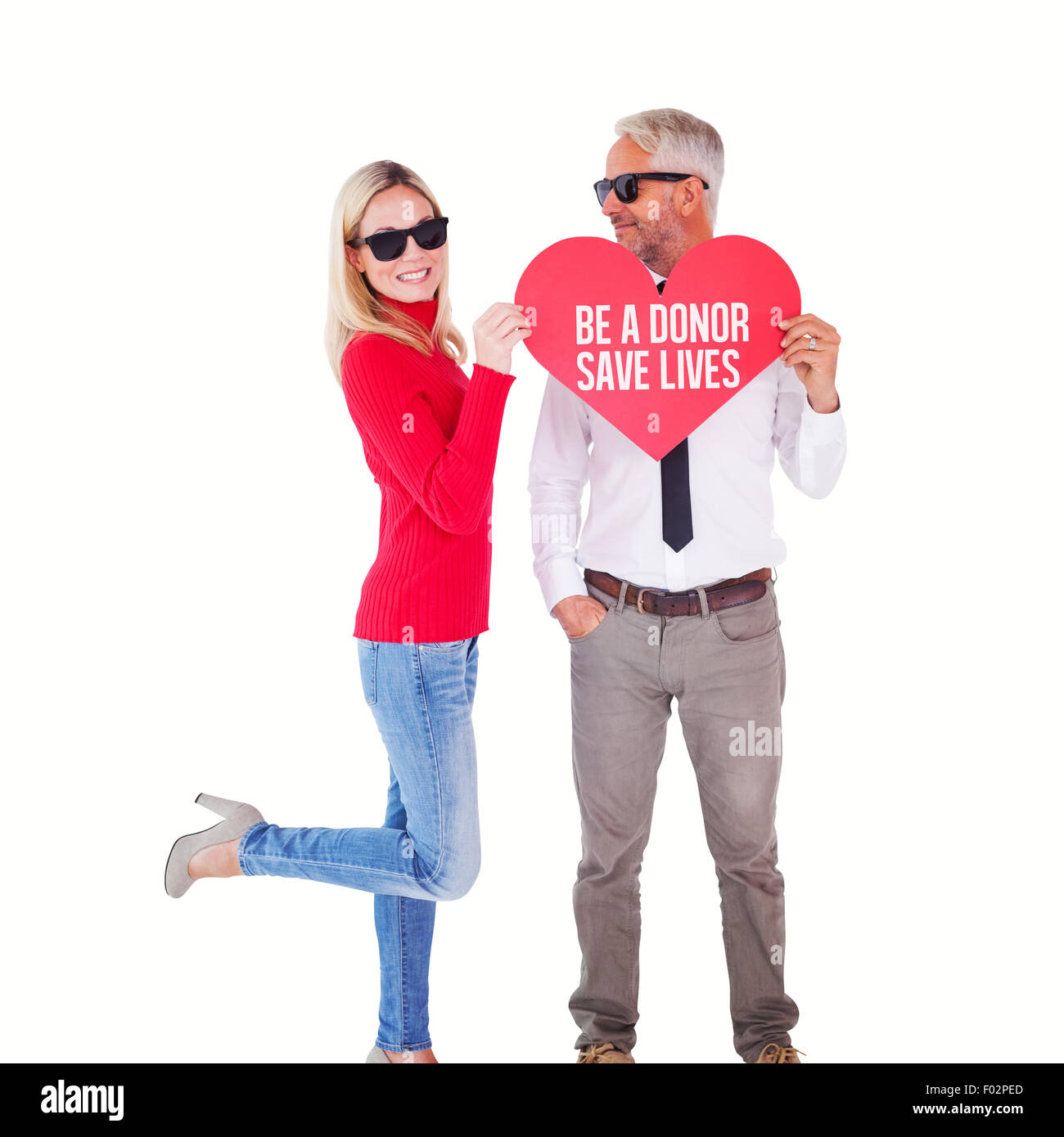 Composite image of cool couple holding a red heart together Stock Photo ...
