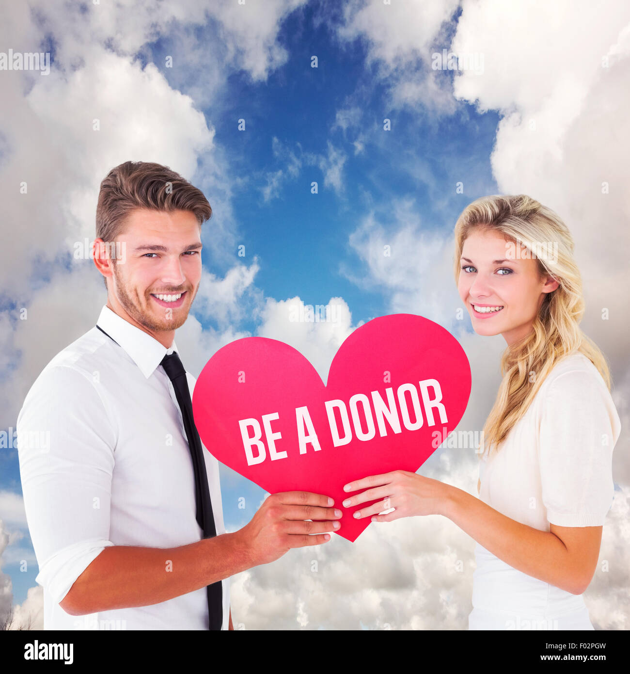 Composite image of attractive young couple holding red heart Stock ...