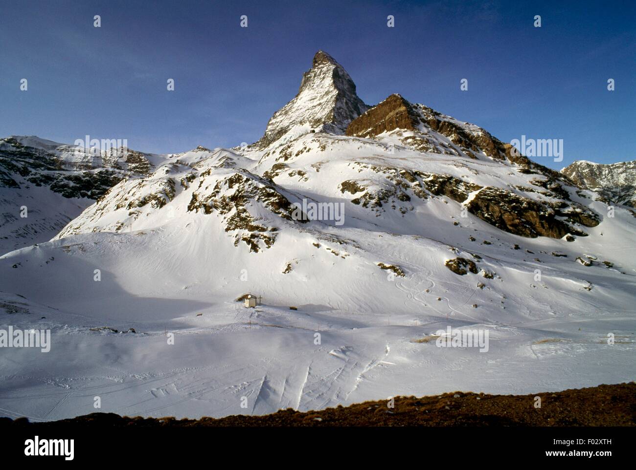 The pyramidal peak of the Matterhorn (4478 metres) seen from Lake ...