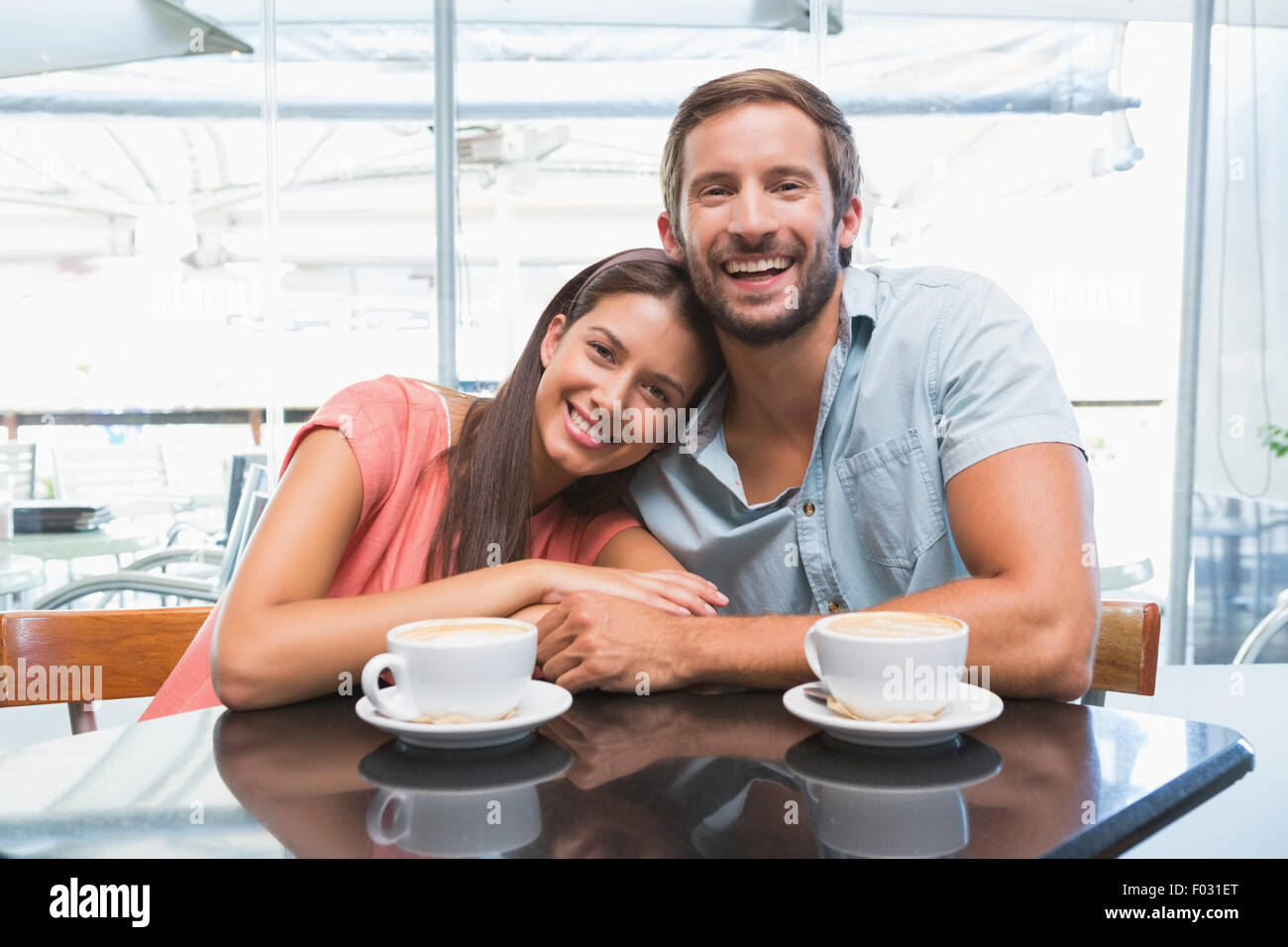 Young happy couple looking at camera Stock Photo - Alamy