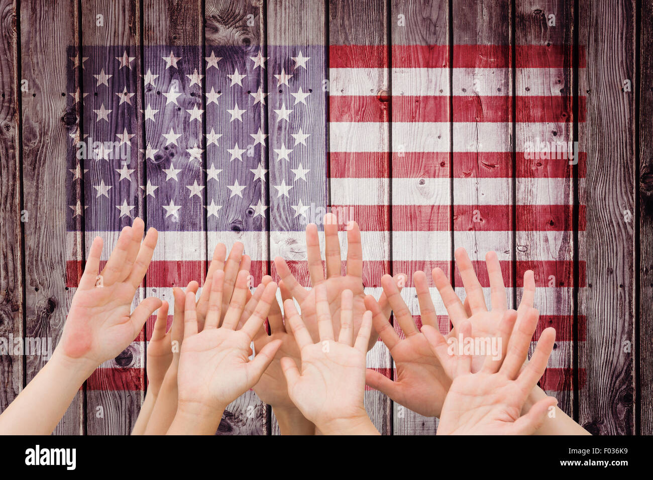 Composite image of people raising hands in the air Stock Photo - Alamy