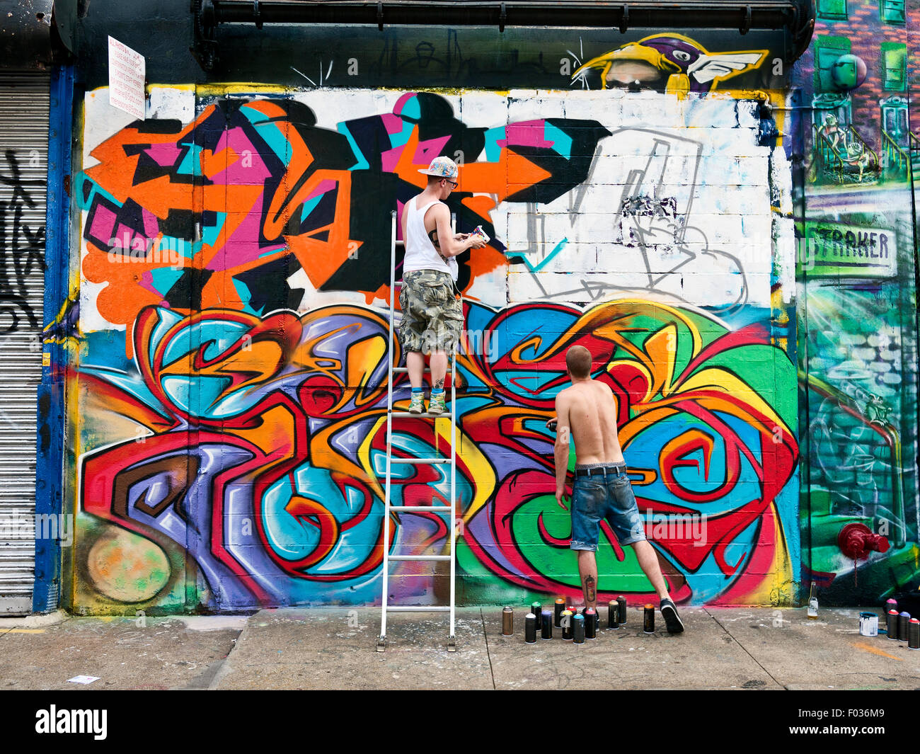 People painting mural at 5 Pointz, Long Island City, Queens, New York, famous as the Graffiti Museum. Stock Photo