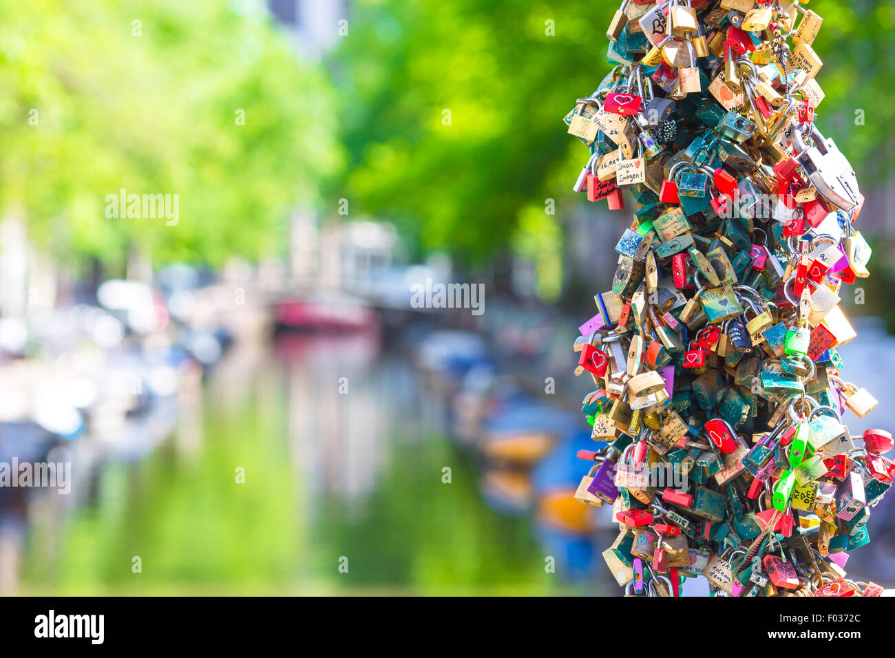 Colorful hundreds of padlockslove locks on canal in Amsterdam
