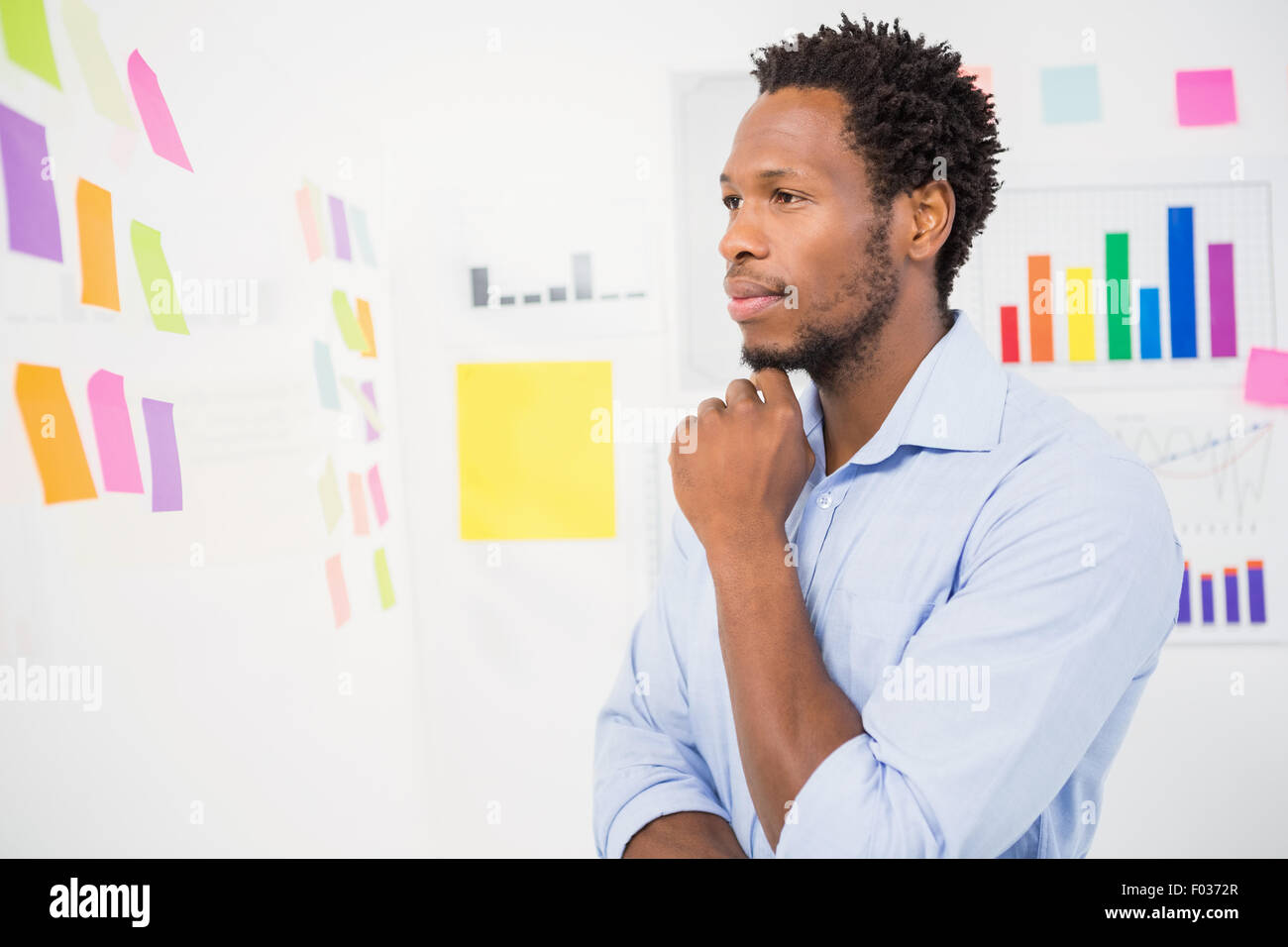 Serious young male designer thinking hi res stock photography and