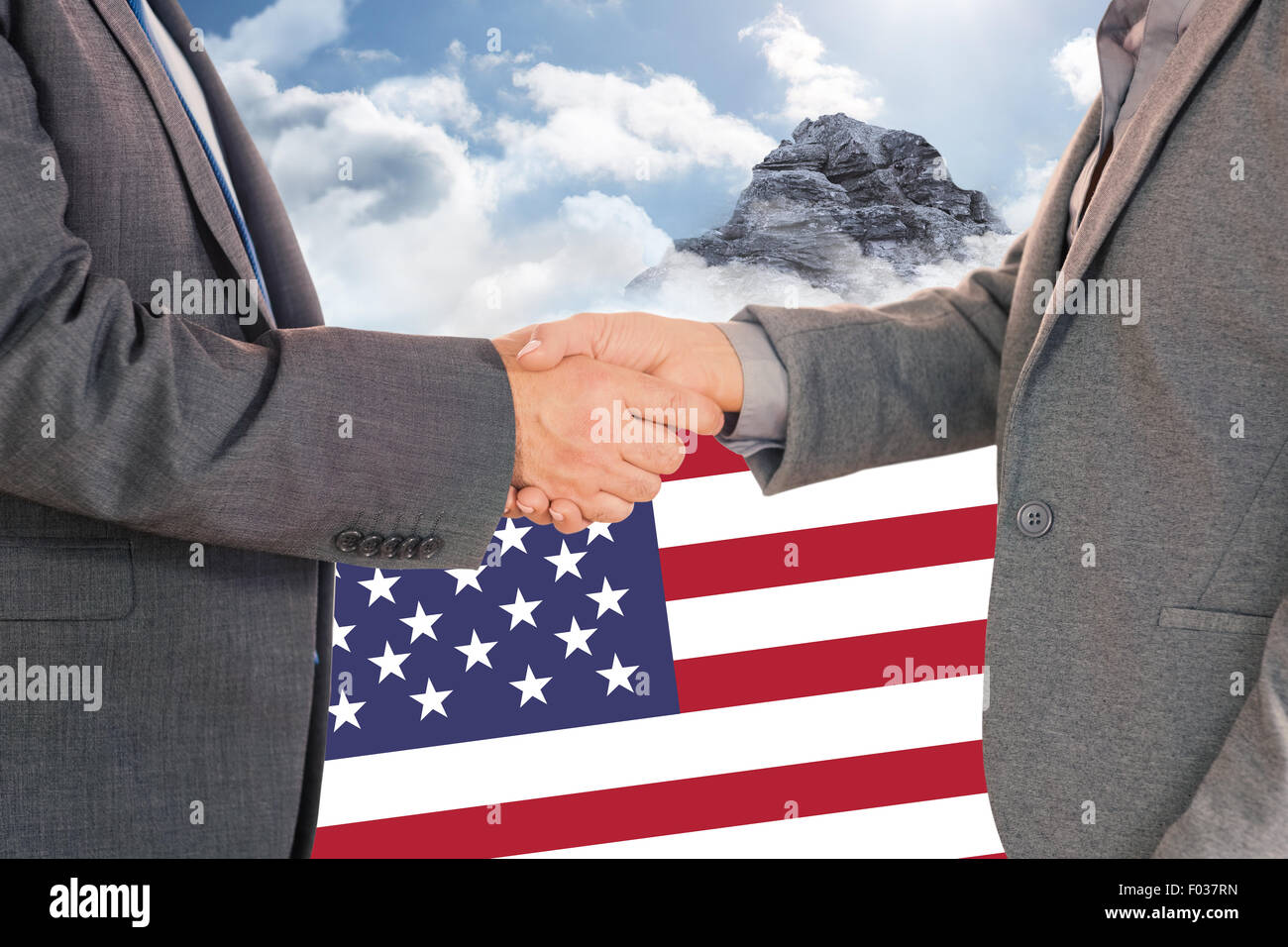 Composite image of close up on two businesspeople shaking hands Stock Photo