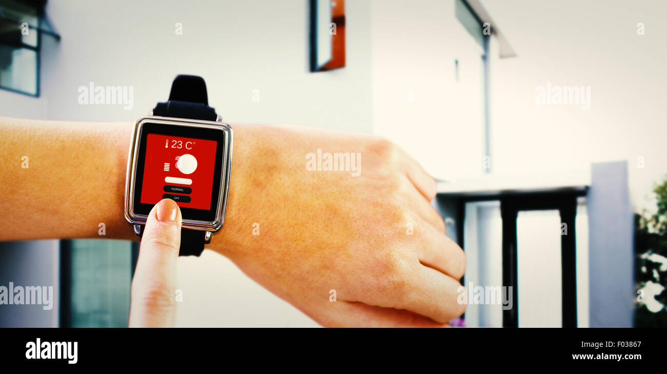 Composite image of smartwatch on wrist Stock Photo